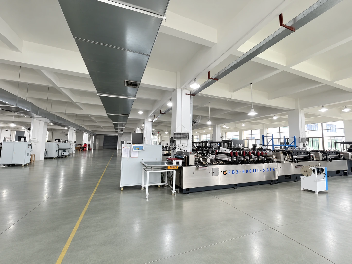 Production equipment and marked aisles inside a Sanfeng packaging workshop